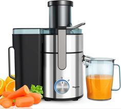 a juicer with carrots, celery and an orange next to it