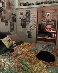 a bed room with a neatly made bed and lots of pictures on the wall