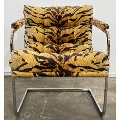 a tiger print chair sitting on top of a cement floor