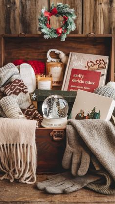 an open suitcase filled with christmas items on top of a wooden table