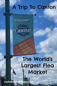 a sign that says the world's largest flea market is hanging from a pole