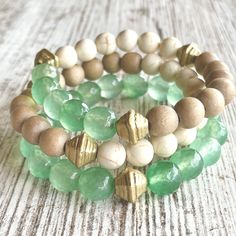 Wow, this one is a looker! The SEAFOAM stack gives off all the warm and pretty feels of the surf meeting the sand. Made with soft muted seafoam-green aventurine gemstones, creamy Calcutta style marble beads, taupe wood beads and gold accents. Buy one or buy all three to create this stunning stack! Save BIG when purchasing all three. (If purchasing one, please note bracelet preference in check out: green, cream/taupe combo or green/cream/taupe combo.)         *Made 7 inches in length for standard wrist unless a custom size is noted in checkout.  *Comes gift-giving-ready with a Salty Sunshine branded tag, sheer drawstring bag and crinkle paper. Holiday gift packing available for small fee - see separate listing.  *Free shipping on orders $35 and up! Follow Salty Sunshine Jewelry on Instagram Leather Jewelry Bracelet, Colorful Bead Bracelets, Cream Marble, Gold Bracelets Stacked, Green Beaded Bracelets, Gems Bracelet, Beaded Jewelry Designs, Beach Lover, Agate Bracelet