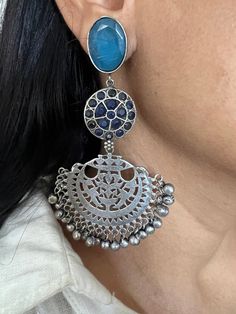 Premium Quality, Silver Replica at its best. Complement your personality with this gorgeous Earrings. Handcrafted in brass, oxidized, stones The weight of the Earrings is 38 grams per pair. The length of the earrings is 10 cm. The width of the earrings is 5 cm. Fusion Style Chandbali Jewelry With Oxidized Finish, Fusion Style Metal Earrings With Latkans, Oxidized Metal Drop Chandelier Earrings, Oxidized Brass Jhumkas, Fusion Style Metal Chandbalis, Heavy Bohemian Sterling Silver Earrings, Bohemian Earrings With Oxidized Finish For Festivals, Oxidized Bohemian Chandbalis Drop Earrings, Oxidized Metal Temple Jewelry Earrings