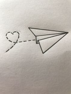 a paper airplane with a heart drawn on it