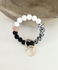 the black and white beaded bracelet with gold charm