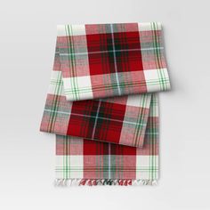 two red and green plaid blankets folded on top of each other with fringes around the edges