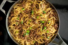 a skillet filled with noodles and ground beef