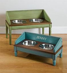 two elevated dog bowls with personalized trays on the top and bottom, sitting on a wood floor