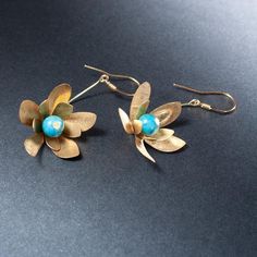 Earrings from the MEADOW collection - flowers with jade and brass petals hanging on a 925 silver ear hook - length 6 cm with ear hook. We make jewelry by hand according to our own designs in the Anillo workshop. The necklace is shipped in an elegant box. Jewelry for women connected with nature, women - flowers, women - birds, women - butterflies :) Elegant Brass Flower Earrings Nickel Free, Elegant Flower Shaped Brass Earrings, Unique Gold Flower Earrings, Handmade Dangle Brass Flower Earrings, Handmade Brass Dangle Flower Earrings, Pierced Brass Dangle Flower Earrings, Handmade Brass Flower Earrings, Handmade Elegant Brass Flower Earrings, Silver Brass Flower Earrings