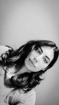 a black and white photo of a woman with long hair