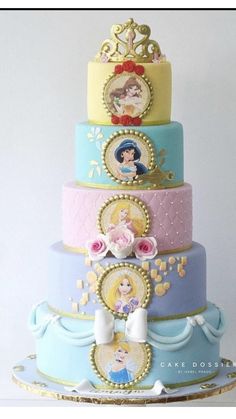 there is a multi layer cake with princesses on it