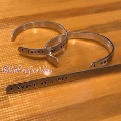 two stainless steel bracelets that say trust, trust and trust with words on them