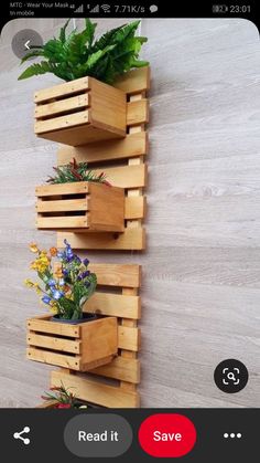 three wooden planters with plants in them on a wall next to a wood floor