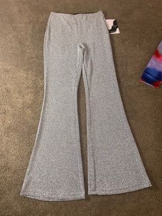 Add a touch of sparkle to your wardrobe with our Grey Glitter Bell Bottoms. These pants feature a glitter style, adding a subtle shimmer to your outfit. Made with high-quality materials, these pants will elevate any look with a touch of glamour. Perfect for a night out or a special occasion. 2-3 day shipping. Glitter grey bell bottom pants. Stretchy fitted, flared bottoms. Flared Bottoms, Boutique Wholesale, Clothing Catalog, Jogging Suit, Bell Bottom Pants, Suit Accessories, Bell Bottom, Mommy And Me, Bell Bottoms