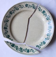 a broken plate on a white table