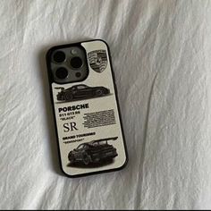 an iphone case that is sitting on top of a white sheet with black and white images