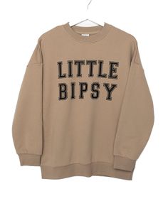 Calling all LB superfans! The most stylish way to show your LB pride is our Collegiate Crewneck, featuring classic 'Little Bipsy' text + the familiar, cozy feel of your favorite college sweatshirt. Pair it with our Athletic Ribbed Biker Short or Legging to rep LB from head to toe! Color: Tan 'LITTLE BIPSY' printed on the front Ribbed neckline, cuffs, and bottom hem Rollable + cinched wrist cuffs Material + Wash: 86.7% cotton | 13.3% polyester Do not bleach Machine wash cold with like colors Dry Trendy Sweatshirt For Campus In Fall, Trendy Campus Sweatshirt For Fall, Trendy Fall Sweatshirt For Campus, Logo Print Sweatshirt For Campus In Fall, Collegiate Logo Print Sweatshirt For Fall, Fall College Sweatshirt With Logo Print, College Logo Print Sweatshirt For Fall, Fall College Logo Print Sweatshirt, Varsity Sweatshirt With Text Print