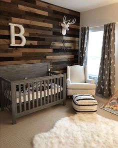 a baby's room with a deer head on the wall