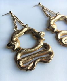 Raw brass chunky snake earrings. Gold plated posts. Handmade Gold Snake Earrings, Handmade Gold Snake-shaped Earrings, Gold Snake-shaped Jewelry With Pierced Ears, Gold Snake Jewelry For Pierced Ears, Gold Snake-shaped Earrings With Pierced Ears, Symbolic Snake-shaped Brass Jewelry, Handmade Brass Snake-shaped Jewelry, Handmade Snake-shaped Brass Jewelry, Handmade Brass Snake Jewelry