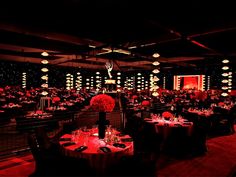 a room filled with lots of tables covered in red lights