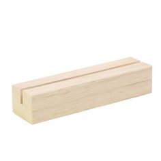 a piece of wood sitting on top of a white surface