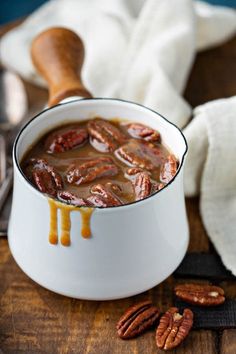 pecan pralie sauce in a white bowl on a wooden table