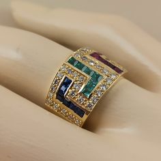 18 Carat (750) solid gold Greek key design ( Meander ) ring with Diamonds ,Emeralds ,Rubies and Sapphires The ring has 48 pieces Brilliant cut diamonds The total weight of the diamonds is 0.70 ct. color grade of the diamonds is ( G ) and clarity grade VS 1 - VVS 2 (Natural diamonds not man made ) and 24 pc. square cut precious stones Emeralds Rubies and Sapphires total weight 1.84 ct. The weight of the ring is 12,40 grams 18 carat (750) It's made in Greece in our workshop in Athens A beautiful G Yellow Gold Multi-stone Emerald Cut Sapphire Ring, Emerald Cut Multi-stone Sapphire Ring In Yellow Gold, Yellow Gold Multi-stone Emerald Cut Diamond Ring, Emerald Cut Multi-stone Sapphire Ring With Diamonds, Emerald Cut Multi-stone Ruby Ring, Greek Coin Pendant, Ancient Greek Coin, Greek Design, Athena Goddess