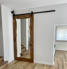 a living room with wooden floors and white walls