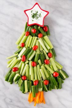 a christmas tree shaped veggie platter with celery and carrots