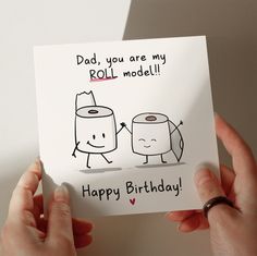 a person holding up a card with two rolls of toilet paper on it that says, dad, you are my roll model happy birthday