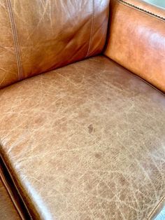 a brown leather chair with no cushions on it