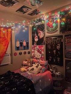 a bedroom decorated with posters, lights and stuffed animals