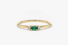 Emerald Ring / Oval Emerald Ring / 14K Gold Oval Cut Emerald with Surrounding Round Cut Diamonds Features * Made to Order. * Gold KT: 14K * Custom Gold Color: Rose Gold, Yellow Gold, White Gold * Round Diamond: 2 pcs 1.3MM * Oval Emerald: 1 pc 3x2 MM * Total Diamond ctw: 0.02ctw * Total Emerald ctw: 0.10ctw * Diamond Color-Clarity: G Color SI Clarity * Setting Type: Prong * Band Width: 1.25mm * Ready to Ship in 7-10 Business Days ▶ See more of our Emerald Jewelry - https://etsy.me/3QCyZBQ ▶ See our storefront here - http://etsy.me/2lUcVnH  ▶ All store sections here * Diamond Rings - http://etsy.me/2lwKUl8 * Diamond Earrings - http://etsy.me/2lyqVBP * Diamond Necklace - http://etsy.me/2mqa6O1 * Diamond Bracelets - http://etsy.me/2mVrAB5 * Diamond Wedding Rings - https://etsy.me/3YbpVq2 * Go Elegant Oval Emerald Stackable Ring, Elegant Oval Stackable Emerald Ring, Classic Oval Stackable Emerald Ring, Yellow Gold Oval Stackable Rings, Yellow Gold Oval Halo Stackable Rings, Yellow Gold Oval Stackable Rings With Halo, Yellow Gold Oval Stackable Rings With Halo Detail, Yellow Gold Stackable Oval Rings With Halo Detail, Push Present Ideas