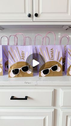 three paper bags with sunglasses on them