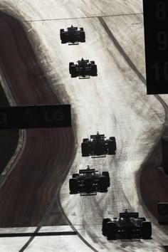 a group of cars driving down a race track with the number 8 on it's side