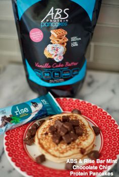 a bag of protein powder next to a plate with pancakes and chocolate chips on it