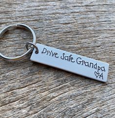 a metal keychain with the words drive safe, you were born