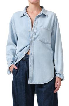 The classic button-up shirt breaks away from its tailored reputation in this soft, oversized chambray version featuring billowy sleeves and a high-low hem. 30 1/2" front length, 32" back length (size Medium) Front button closure Spread collar Long sleeves with button cuffs Chest patch pocket 70% lyocell, 30% recycled cotton Machine wash, tumble dry Made in the USA Classic Washed Blue Shirt For Workwear, Relaxed Fit Light Wash Shirt With Snap Buttons, Light Wash Shirt With Snap Buttons And Relaxed Fit, Unstructured Tops For Spring Workwear, Classic Washed Blue Top With Button Cuffs, Classic Washed Blue Tops With Button Cuffs, Spring Washed Blue Tops With Button Cuffs, Unstructured Washed Blue Shirt For Work, Classic Button-up Blouse For Casual Gatherings