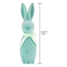 a green stuffed animal with a bow on it's head and measurements for the height