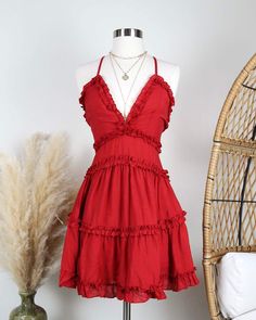 A stylish dress that is easy to put on, making you the cutest one almost... Vacation Mini Dress With Ruffled Straps, V-neck Ruffled Sundress Mini Dress, V-neck Mini Dress With Crisscross Straps For Day Out, Chic Red V-neck Sundress, Flirty V-neck Ruffle Dress For Summer, Flirty Mini Dress With Ruffled Straps For Vacation, Chic Mini Dress With Ruffled Straps For Vacation, Chic Vacation Dress With Crisscross Straps, Chic Dress With Crisscross Straps For Vacation