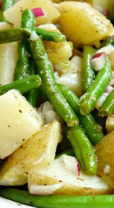 a white plate topped with green beans and potatoes