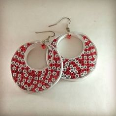 pair of red and white beaded hoops on silver earrings with dangling hooks,