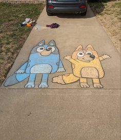 two cartoon characters painted on the sidewalk next to a car