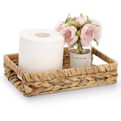 two rolls of toilet paper in a basket with flowers