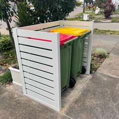 two trash cans sitting next to each other on the sidewalk