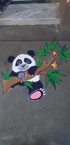 a panda bear is sitting on a tree branch painted on the sidewalk with stars and leaves