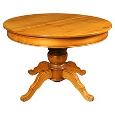 a round wooden table with four leaves on the top and one leaf at the base