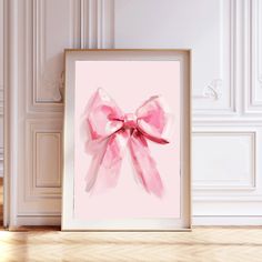 a pink bow is hanging on the wall