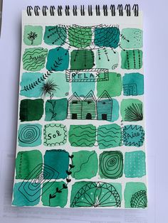 a notebook with green and blue designs on it