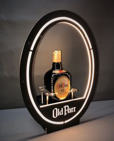 a bottle of liquor is sitting in a circular light up holder with the word old parr on it